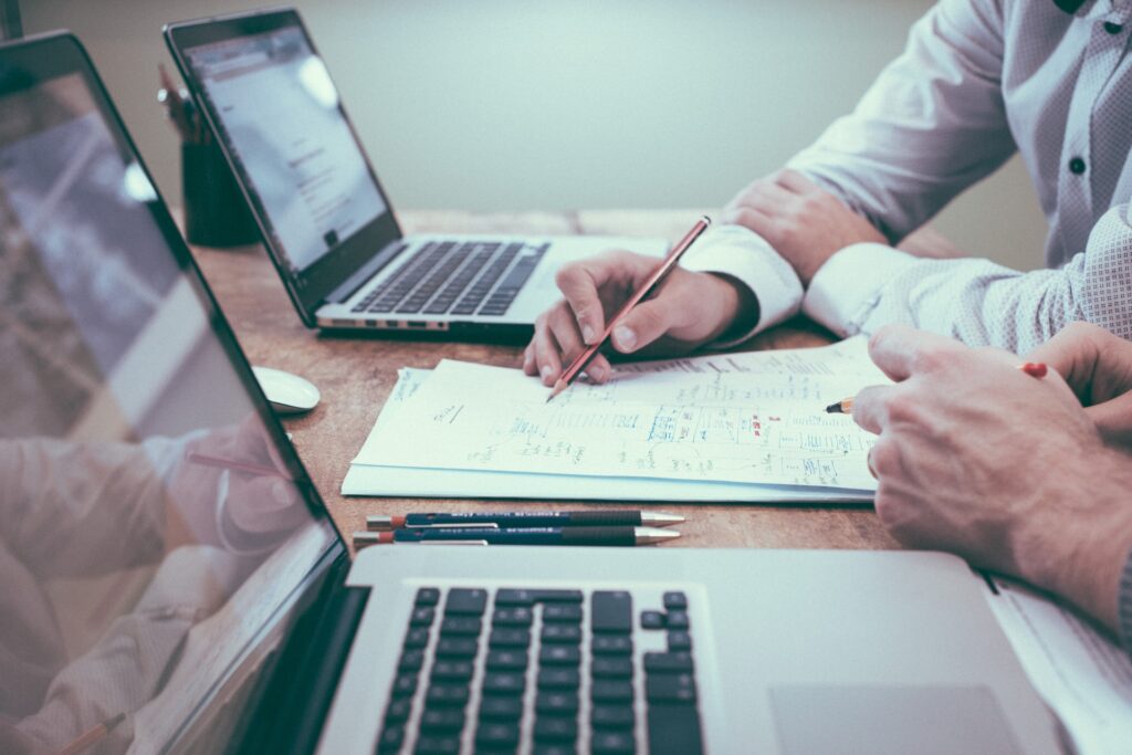two people by laptops measuring your website’s effectiveness