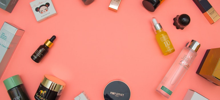 skincare products on a pink surface