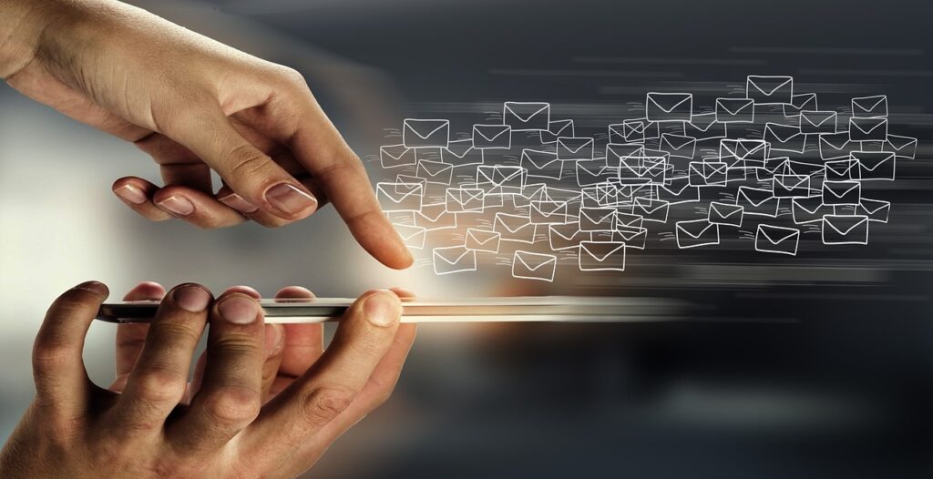 An illustration of a finger sending emails through a mobile device.