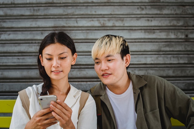 Woman and a man looking at a smartphone together