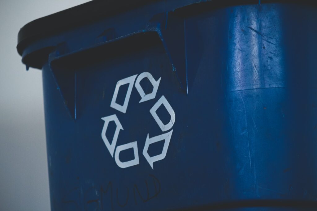 A blue recycling bin