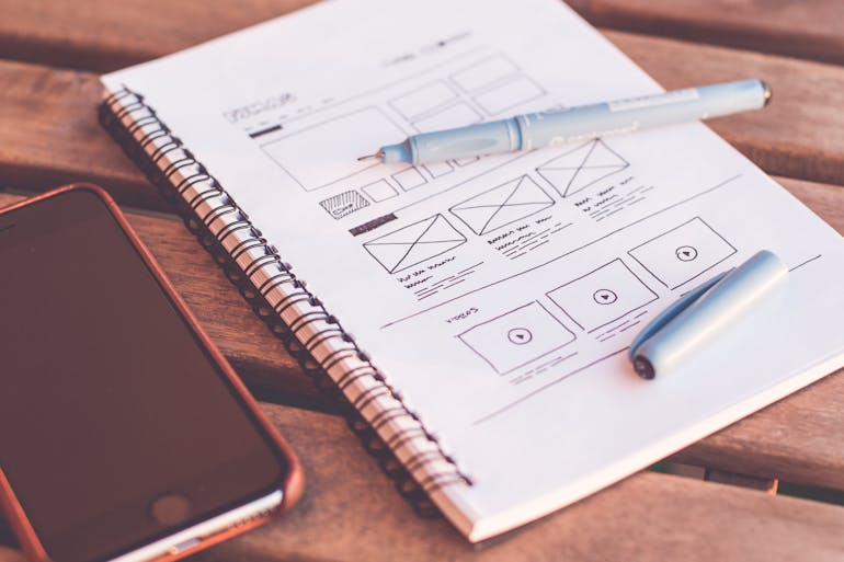 A notebook with website minimalist design ideas.