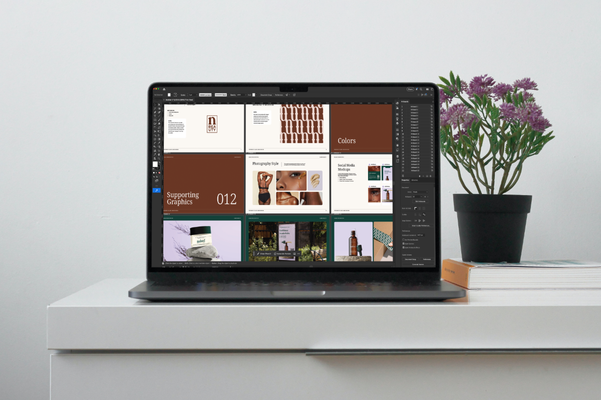Adobe Illustrator laptop mockup showcasing the brand presentation template in use by a designer.