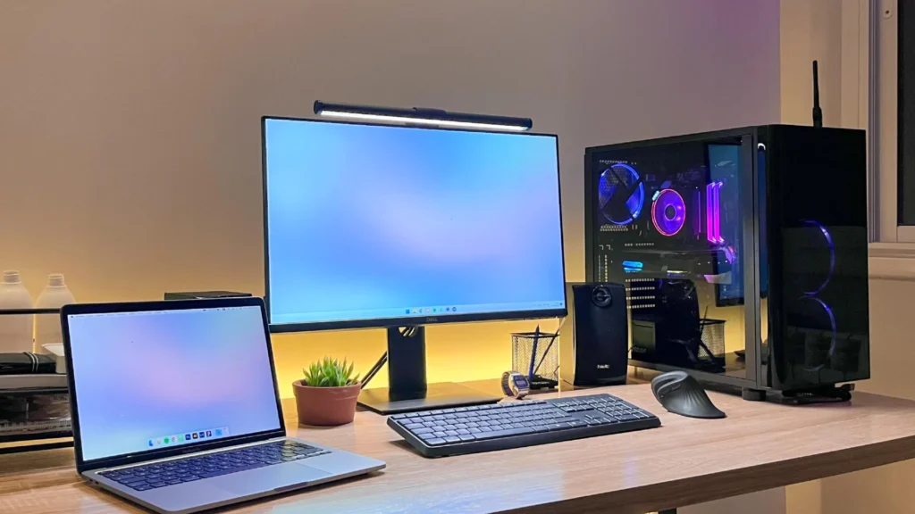 Solo designer's desk setup with laptop and notebook, representing a lean studio workflow